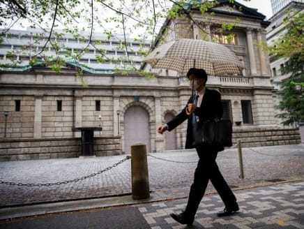 An office employee walks in front of the bank of Japan building in Tokyo, Japan, April 7, 2023. REUTERS/Androniki Christodoulou