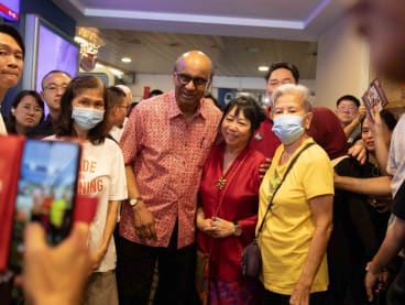 Mr Tharman Shanmugaratnam and his wife Jane Ittogi posing for photos with supporters at Toa Payoh Hub on Sept 2, 2023.